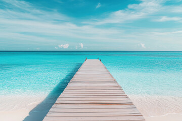 Obraz premium Tranquil scene with a weathered pier leading to the crystal clear ocean. Ideal for travel, vacation, and relaxation themes.