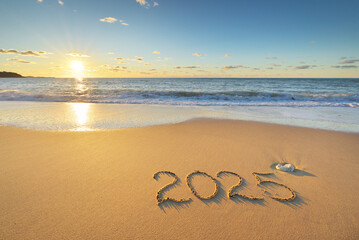 2025 year on the sea sand beach shore during sunset.