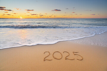 2025 year on the sea shore during sunset.