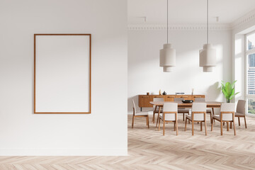 Blank framed poster mockup on a white wall in a modern dining room with wooden furniture, pendant lights, and large windows. 3D Rendering. 3D Rendering