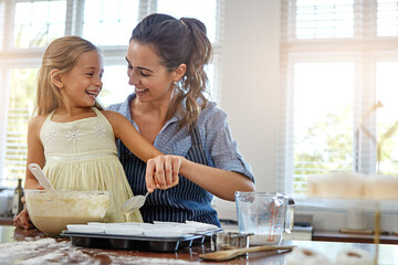 Mother, girl and baking support in kitchen with helping, culinary education and teaching muffin...