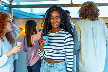 Beauty african woman smiling in a roof party with friends