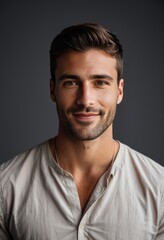 Fototapeta premium portrait of a smiling man, soft lighting, white shirt, dark background, handsome, casual elegance, shallow depth of field, studio photography style 