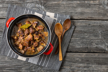 beer braised pork stew in a red pot