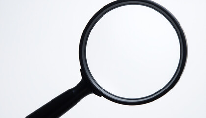 The image displays a magnifying glass with a round, clear lens and a black handle. It is positioned against a neutral background. There are no texts or additional objects visible in the image.