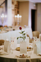 Elegant Table Setting with Single Red Rose Centerpiece