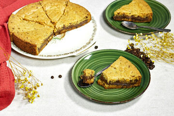 chocolate chip cookie cake on gray background with coffee beans and gypsophila flowers