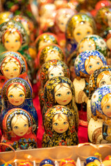 Close-up view of group of various beautiful traditional Russian Matryoshka dolls on market stall. Soft focus. Copy space. Souvenirs from Russia theme.