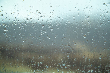 Raindrops on the glass from the car.