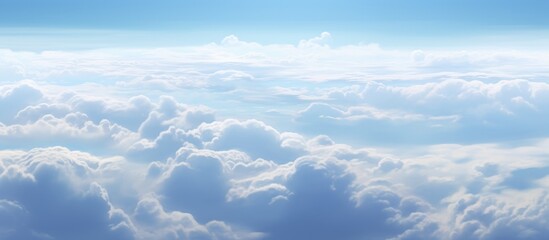 Fototapeta premium Stunning aerial view of soft clouds from an airplane window showcasing the beauty of sky and atmosphere amidst serene blue hues.