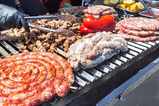 Street food with huge barbecue with many cuts of different meat of traditional Italian and Sicilian roast on grill