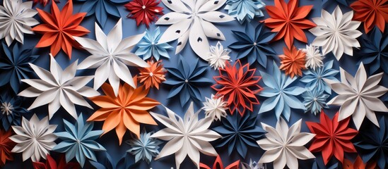 Colorful paper snowflakes arranged artistically on a textured fabric background creating a festive and decorative ambiance.