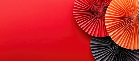 Oriental paper fans in vibrant colors on a red backdrop minimalistic decoration concept for celebrations or cultural events flat lay perspective