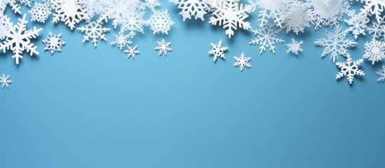 Snowflakes border design on a blue background creating a festive winter atmosphere with ample copy space for text insertion