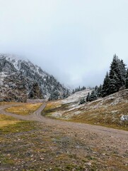 Into the mountain landscape under a foggy sky