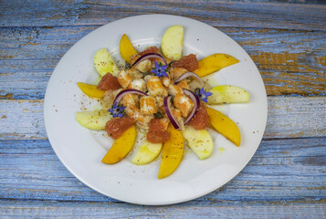 RECIPE CEVICHE OF SHRIMPS AND SCALLOPS WITH CITRUS FRUIT, LEMON, LIME, SQUEEZED ORANGE, GRAPEFRUIT AND FRUIT, PERSIMMON, APPLE, SEASONED WITH ESPELETTE PEPPER. High quality photo