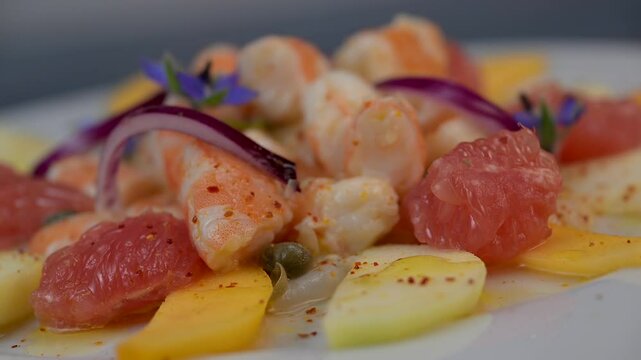 RECIPE CEVICHE OF SHRIMPS AND SCALLOPS WITH CITRUS FRUIT, LEMON, LIME, SQUEEZED ORANGE, GRAPEFRUIT AND FRUIT, PERSIMMON, APPLE, SEASONED WITH ESPELETTE PEPPER. High quality 4k footage