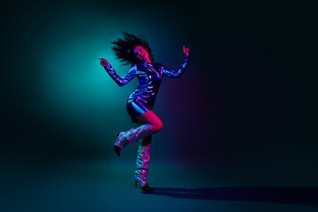 Full body photo of attractive young woman dance dressed stylish party retro clothes isolated on dark background