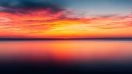 Fototapeta premium Breathtaking Sunset Over Calm Waters with Vibrant Shades of Orange, Pink, and Blue Creating a Serene Atmosphere for Tranquil Scenic Views and Nature Lovers