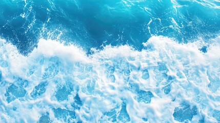 Obraz premium Aerial view of vibrant turquoise ocean waves crashing and creating splashes and foam, perfect for abstract nature backgrounds and textures with dynamic movement and color.