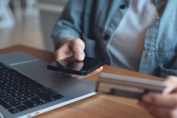 Online banking, digital payment, e-transaction concept. Woman using mobile phone and credit card for internet payment, digital wallet, e-commerce, financial technology