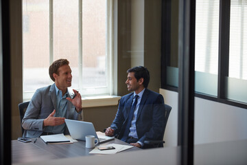 Laptop, business plan and men in office with discussion, advice or collaboration for budget proposal. Consultant, financial advisor and businessman in meeting for project management, pitch or ideas