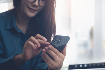 Woman using mobile phone for online shopping and digital banking via mobile app, close up. Asian business woman chatting on smartphone, social media networking, modern people lifestyle