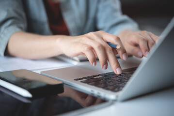 Close up, woman hand typing on laptop computer keyboard. Business woman online working on laptop...