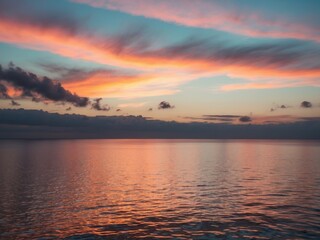 Obraz premium Vibrant Sunset Over Calm Ocean Reflecting Colorful Sky.
