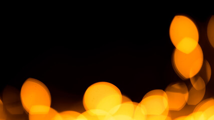 Bright yellow, gold lights, bokeh on black background