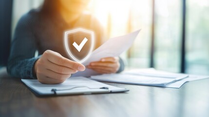 A person holding a security shield icon with a checkmark alongside documents, symbolizing safety, trust and REIT involvement in real estate investments