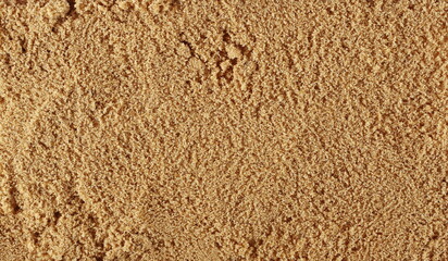 Pile brown unrefined sugar, muscovado background and texture, top view