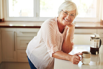 Elderly woman, coffee and portrait in kitchen for relax, morning caffeine and comfort routine in...