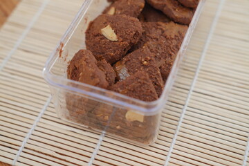 Homemade cookies with almonds on wooden background.