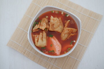 delicious red tofu soup with crackers