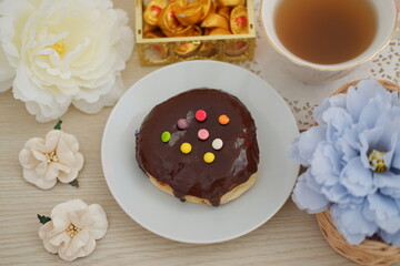 donut and cup of tea on the red table