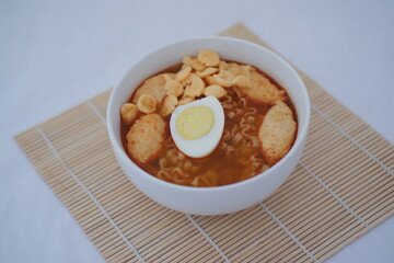 spicy egg noodle soup with crackers