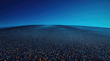 Vast expanse of smooth asphalt under a clear blue sky, creating a serene and tranquil atmosphere with a flat horizon.