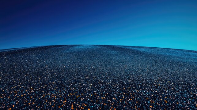 Vast expanse of smooth asphalt under a clear blue sky, creating a serene and tranquil atmosphere with a flat horizon.