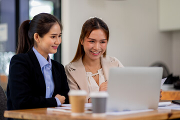 Two asian business women Accounting using calculating income-expenditure and analyzing real estate investment documents data report Financial and tax systems concept.