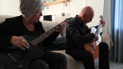 Senior couple practice electric and spanish guitar - Powered by Adobe