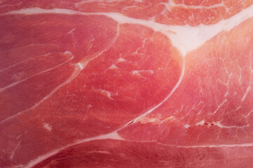 Hamon meat thin slice as macro photo background.