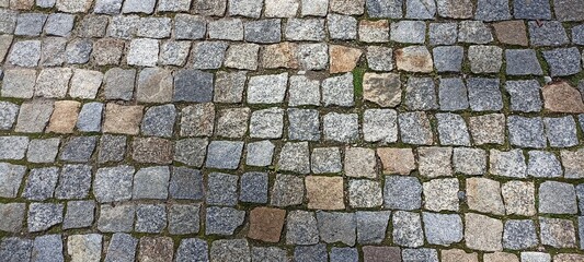 the surface is paved with cobblestones, square stones