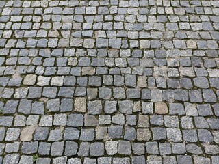 the surface is paved with cobblestones, square stones