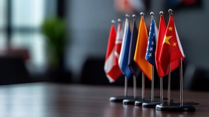 Colorful international flags displayed on a wooden table, symbolizing global diplomacy and cooperation in a modern office setting, showcasing diverse nations in harmony.