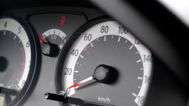Closeup of car speedometer dashboard with speed dial in kilometers per hour and fuel gauge, stationary parked used vehicle instrument panel detail, no motion, service repairs symbol, abstract concept