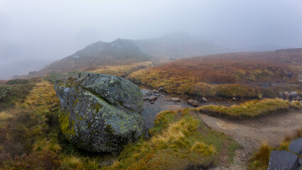 Misty Mountain Landscape with Moss-Covered Rock