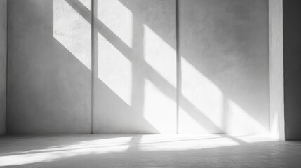 Obraz premium Spacious minimalistic room backdrop with grey-white walls, illuminated by sunlight creating dynamic shadows and light patterns on the surface.