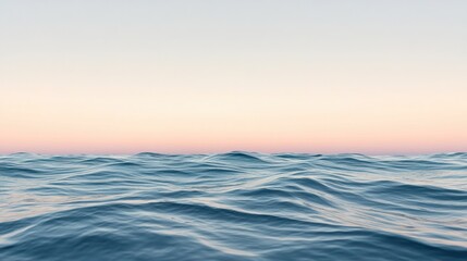 Fototapeta premium Serene view of the sea with gentle waves and a distant horizon under a pastel-colored sunset sky