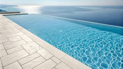 Infinity pool overlooking calm ocean at sunset with clear sky